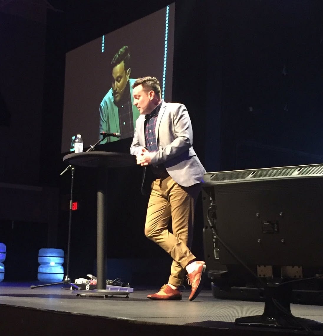Stephen speaking on stage, his image projected on the screen behind him